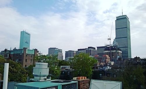 Modern buildings against cloudy sky