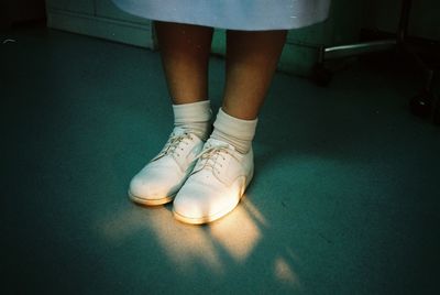 Low section of girl standing on floor