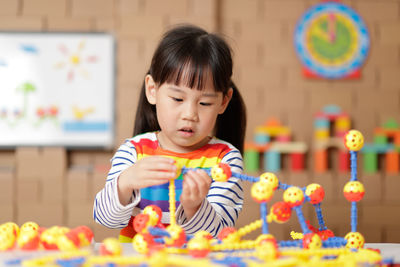 Cute boy holding toy toys