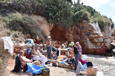 Group of people sitting on rock