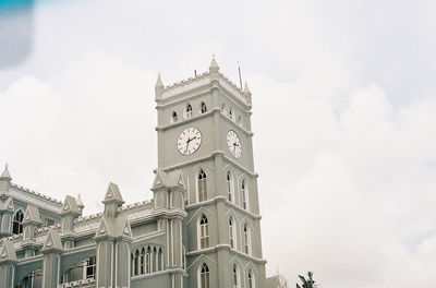 Low angle view of clock tower against sky