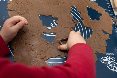 Low section of person holding jigsaw piece