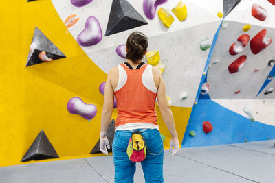 Woman climbing on wall