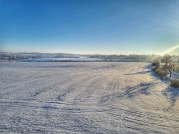 Scenic view of snow covered landscape against sky