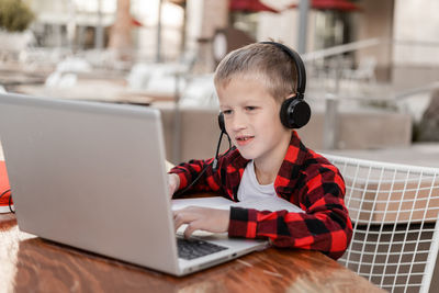 Young woman using laptop at table