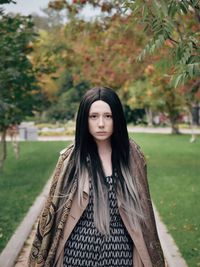 Front view of young woman walking in park