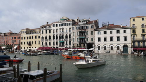 Boats in river with buildings in background