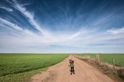 Rear view of man on dirt road