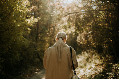 A young woman walking in the woods during autumn