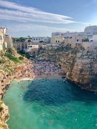 High angle view of buildings by sea against sky