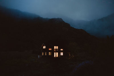 House on mountain against sky at night