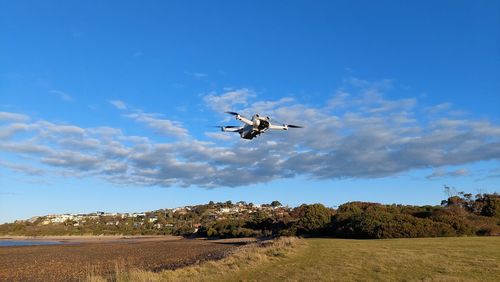 Low angle view of airplane flying against sky