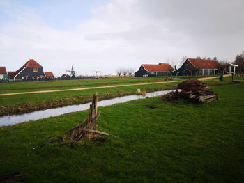 Houses on field against sky