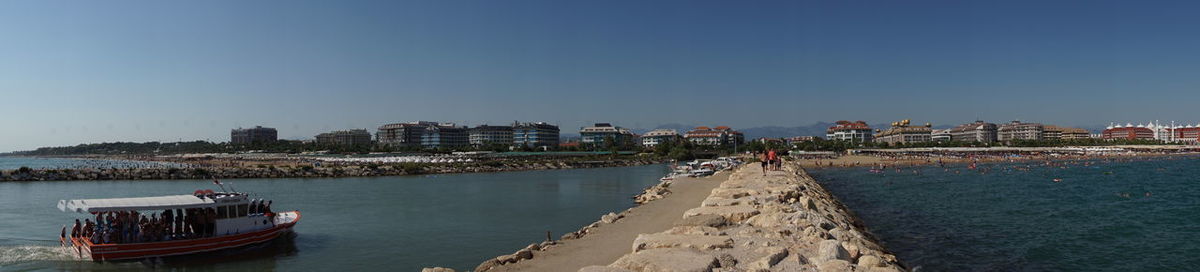 Panoramic view of sea and buildings against clear sky