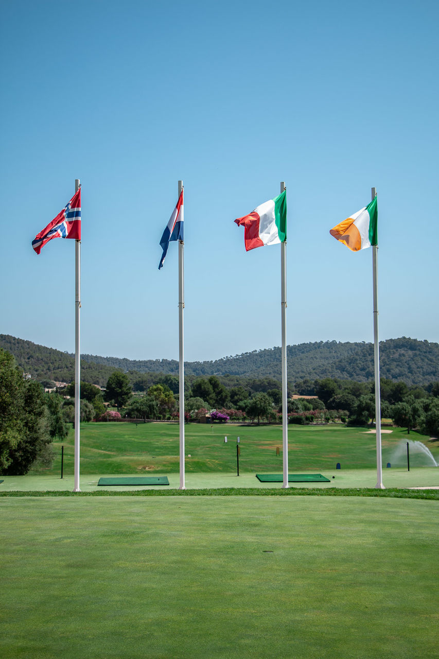 FLAGS AGAINST CLEAR SKY