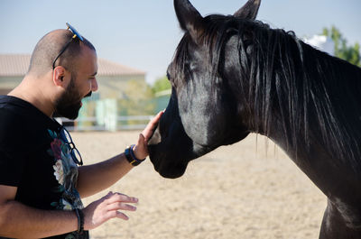 Midsection of man with horse