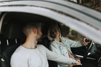 Rear view of people sitting in car
