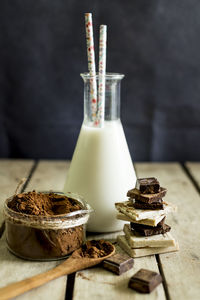 Close-up of chocolates and milk on table