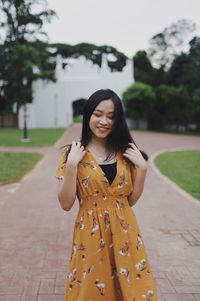 Portrait of a smiling young woman standing outdoors