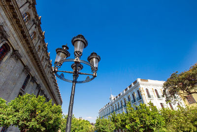 Low angle view of street light against building