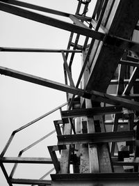 Low angle view of crane against sky