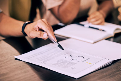 Midsection of man working on table