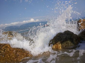 Waves splashing on rocks at shore