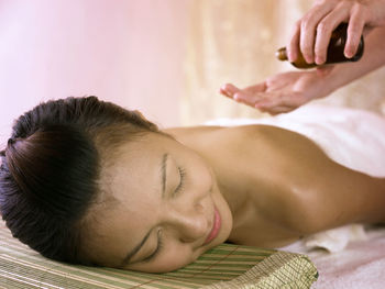 Close-up of woman giving massage to customer at spa