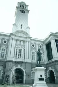 Low angle view of statue against building in city