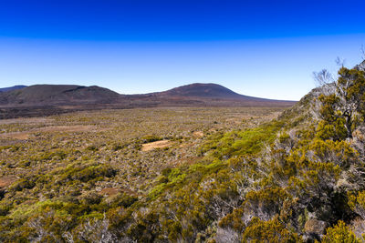 Scenic view of landscape against clear blue sky