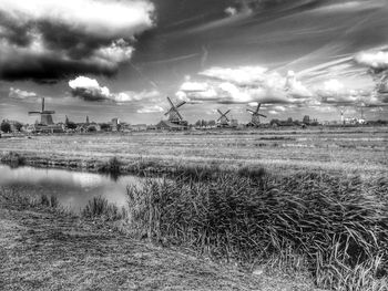 Scenic view of field against cloudy sky