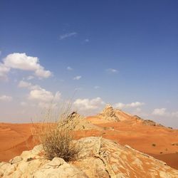 Scenic view of desert against blue sky