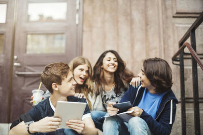 Happy teenagers enjoying on steps outdoors