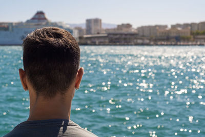 Rear view of man looking at sea