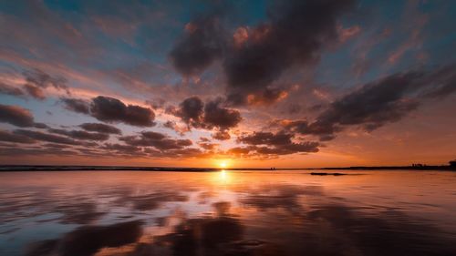 Scenic view of sea against romantic sky at sunset