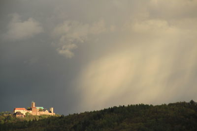 Panoramic view of trees and buildings against sky