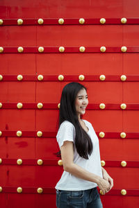 Full length of a smiling young woman