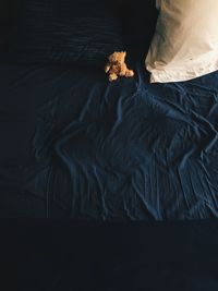 Low section of person relaxing on bed at home