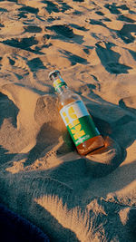 High angle view of bottles on beach