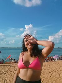 Beautiful woman on beach against sky