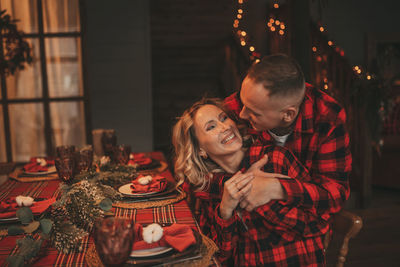 Candid authentic happy married couple spends time alone at lodge xmas decorated