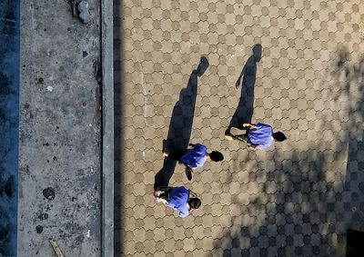 High angle view of people on cobblestone