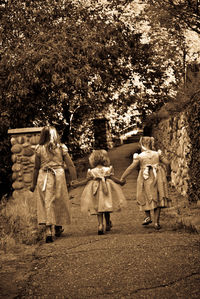 Woman standing on tree trunk