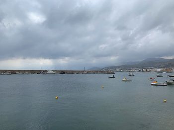 Sailboats in sea against sky