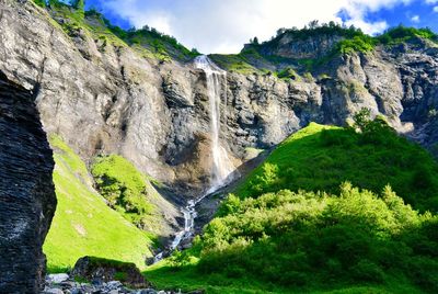 Scenic view of waterfall against sky