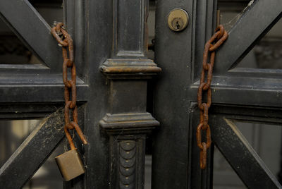 Rusty broken chains hanging on door