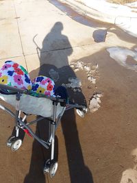 High angle view of shadow of bicycle on sand