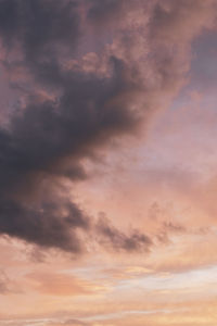 Low angle view of cloudy sky at sunset