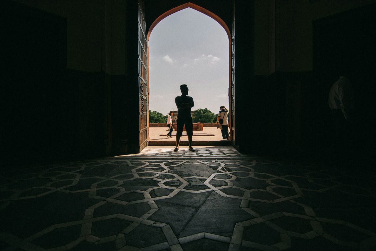 full length, silhouette, rear view, men, walking, lifestyles, arch, architecture, indoors, built structure, leisure activity, the way forward, standing, person, tunnel, archway, building exterior