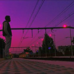 Man standing on illuminated city at night